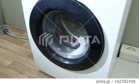 Clothing in White Modern domestic washing machine. Close up vide 142782436