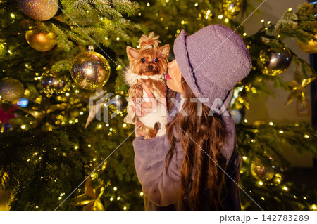 happy girl near a decorated New Year's tree 142783289