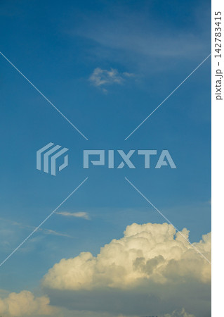 Vast blue sky with fluffy white cumulus clouds on a sunny day Vast blue sky with fluffy white cumulus clouds on a sunny day 142783415
