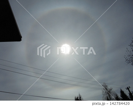 Optical phenomenon circular halo rainbow around sun during winter. Optical phenomenon circular halo rainbow around sun during winter. 142784420
