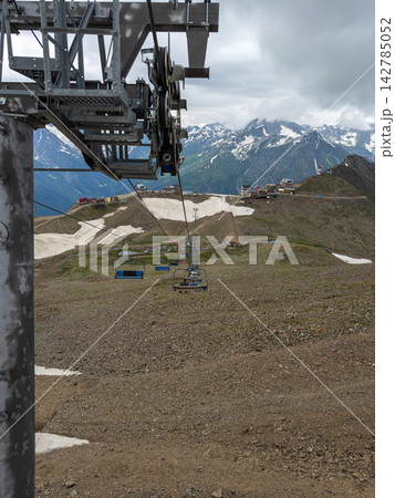 Cable car glides over summer mountains Cable car glides over summer mountains 142785052