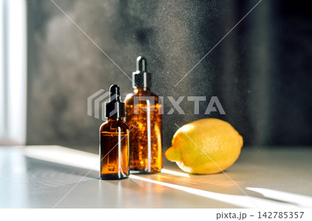 Natural skincare essence with lemon and dropper bottles 142785357