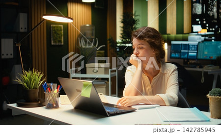 Businesswoman makes mistake in transcribing finance updates on notebook, tearing up the paper sheet and restarting. Discontent impatient worker wanting to finish tasks for the night. Camera A. Businesswoman makes mistake in transcribing finance updates on notebook, tearing up the paper sheet and restarting. Discontent impatient worker wanting to finish tasks for the night. Camera A. 142785945