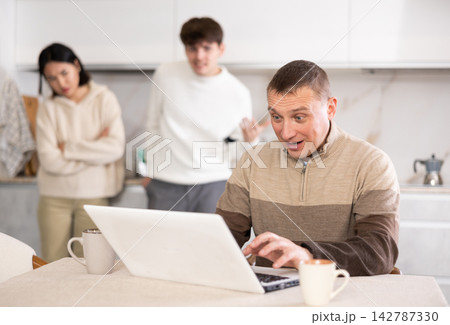Couple quarreling with adult man with laptop Couple quarreling with adult man with laptop 142787330