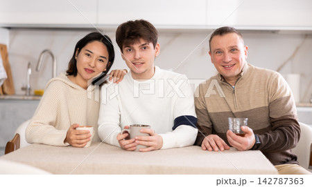 Portrait of happy family - married couple and father at home 142787363