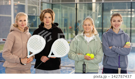 Group photo of four padel players standing in court Group photo of four padel players standing in court 142787437