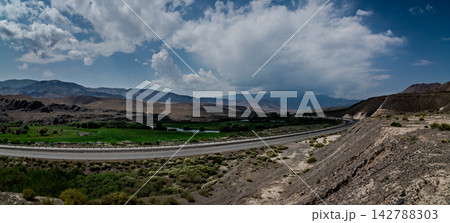Wide valley highway and dramatic clouds along the road to Bishkek Kyrgyzstan 142788303