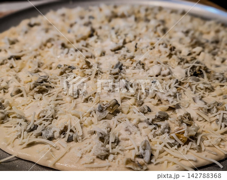 Uncooked white clam pie pizza on metal pan 142788368