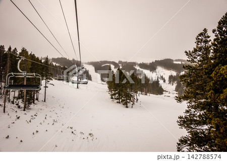 Breckenridge Ski Resort Colorado Snow Covered Terrain Park and Mountain Lodge Buildings in Winter Snowfall with Overcast Conditions 142788574