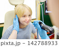 A skillful male ENT doctor examines a young patient's nose with an endoscope in a medical office of clinic. A professional otolaryngologist is at his workplace 142788933