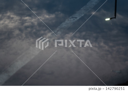 Reflection of street lights and sky on flood puddle on the road Reflection of street lights and sky on flood puddle on the road 142790251
