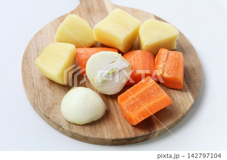 Chopped fresh vegetables including carrots, potatoes, and onions Chopped fresh vegetables including carrots, potatoes, and onions 142797104