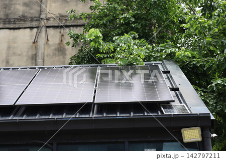 Solar panels installed on a corrugated metal roof 142797211