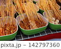 Traditional Sichuan boboji skewers with tripe and quail eggs in green bowls. 142797360