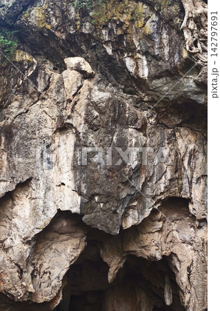 Low angle view of a dark cave exit Low angle view of a dark cave exit 142797691
