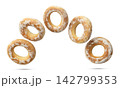 Dry bagels flying close-up on a white background. Isolated 142799353
