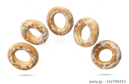 Dry bagels flying close-up on a white background. Isolated Dry bagels flying close-up on a white background. Isolated 142799353