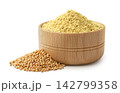 Ground mustard in a wooden bowl and mustard seeds close-up on a white background. Isolated 142799358