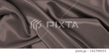 Smooth elegant brown silk or satin luxury cloth texture as abstract background. Luxurious background design. In Sepia toned. Retro style Smooth elegant brown silk or satin luxury cloth texture as abstract background. Luxurious background design. In Sepia toned. Retro style 142799555