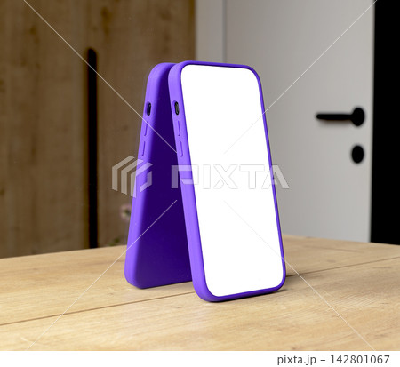 Pair of smartphone mockups with blank white screens and purple frames lean together on a wooden 142801067