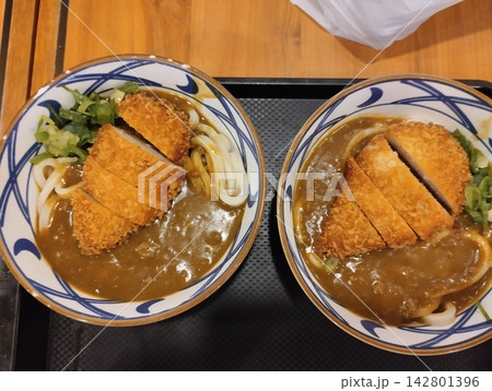 Two Bowls of Japanese Chicken Katsu Curry Udon Noodles with Crispy Fried Cutlet on Tray Two Bowls of Japanese Chicken Katsu Curry Udon Noodles with Crispy Fried Cutlet on Tray 142801396