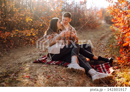 Stylish couple walking and enjoying autumn weather. People, lifestyle, vacations concept. Autumn. Stylish couple walking and enjoying autumn weather. People, lifestyle, vacations concept. Autumn. 142801917