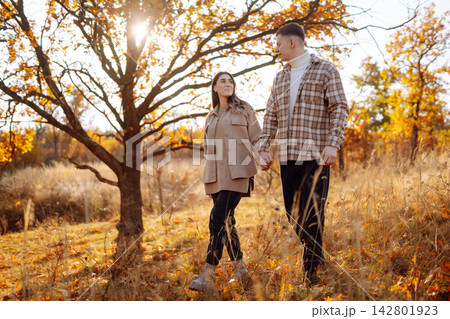 Stylish couple walking and enjoying autumn weather. People, lifestyle, vacations concept. Autumn. Stylish couple walking and enjoying autumn weather. People, lifestyle, vacations concept. Autumn. 142801923