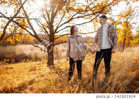 Stylish couple walking and enjoying autumn weather. People, lifestyle, vacations concept. Autumn. Stylish couple walking and enjoying autumn weather. People, lifestyle, vacations concept. Autumn. 142801924