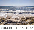 A breathtaking sunny view of a wild rocky beach where powerful ocean waves crash on the shore, evoking a sense of calm and freedom. Ideal for travel and wellness projects. Nobody. 142801978
