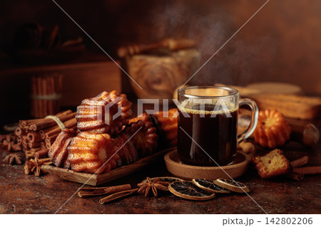 Rum caneles and mug of black coffee. Rum caneles and mug of black coffee. 142802206