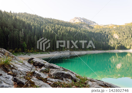 Beautiful view of lake. Rocky shore of mountain lake in the morning. Travelling, lifestyle, nature Beautiful view of lake. Rocky shore of mountain lake in the morning. Travelling, lifestyle, nature 142802746