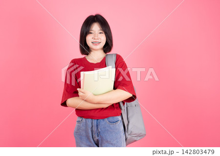 Asian College Girl Student Holding Book Paper Studio Isolated Pink Background Concept Asian College Girl Student Holding Book Paper Studio Isolated Pink Background Concept 142803479
