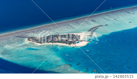 Breathtaking panoramic aerial reef sandbar splitting vivid azure Maldives lagoon deep blue tropical sea wide paradise. Perfect summer travel vacation island getaway. Exotic honeymoon holiday coast Breathtaking panoramic aerial reef sandbar splitting vivid azure Maldives lagoon deep blue tropical sea wide paradise. Perfect summer travel vacation island getaway. Exotic honeymoon holiday coast 142803515