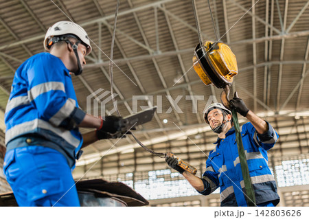 Technician Control Operate Hoist Crane Control Lifting Machine Parts In Old Machinery Workshop. Technician Control Operate Hoist Crane Control Lifting Machine Parts In Old Machinery Workshop. 142803626