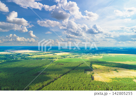 Rural landscape, aerial view. View of plowed and green fields and forest in spring. Rural landscape, aerial view. View of plowed and green fields and forest in spring. 142805255