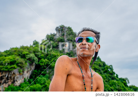 Asian man wearing sunglasses on vacation in thailand Asian man wearing sunglasses on vacation in thailand 142806616