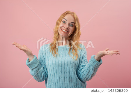 Young adult woman with a confused or indifferent expression shrugging hands, posing against a solid pink background, portraying uncertainty and asking a question Young adult woman with a confused or indifferent expression shrugging hands, posing against a solid pink background, portraying uncertainty and asking a question 142806890