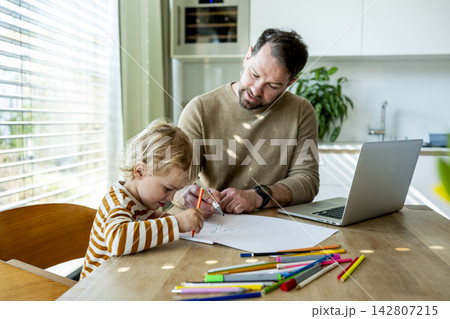 Father educating toddler about solar power and eco friendly living. 142807215