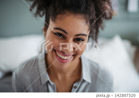 Portrait of beautiful young woman with curly hair. 142807320
