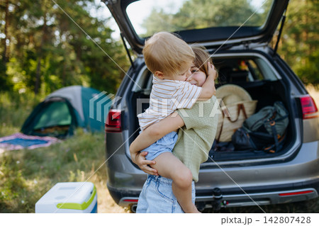 Family getting camping equipment from car after arriving in nature. 142807428
