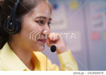 Professional Call Center Assistant Wearing Headset 142808979