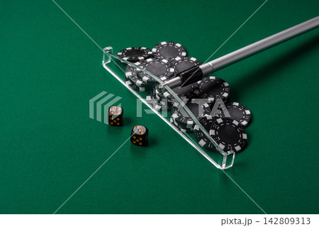 Dice and chips on a green felt gaming table, a poker game in a casino. Casino dice Dice and chips on a green felt gaming table, a poker game in a casino. Casino dice 142809313