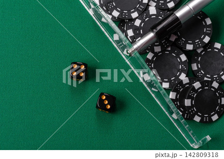 Dice and chips on a green felt gaming table, a poker game in a casino. Casino dice Dice and chips on a green felt gaming table, a poker game in a casino. Casino dice 142809318