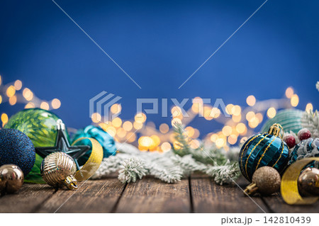 Christmas Ornaments in Navy and Teal with Gold Ribbon on Blue Christmas Ornaments in Navy and Teal with Gold Ribbon on Blue 142810439