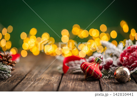 Red Plaid Christmas Ornament with Gold Ribbon on Rustic Wood Red Plaid Christmas Ornament with Gold Ribbon on Rustic Wood 142810441