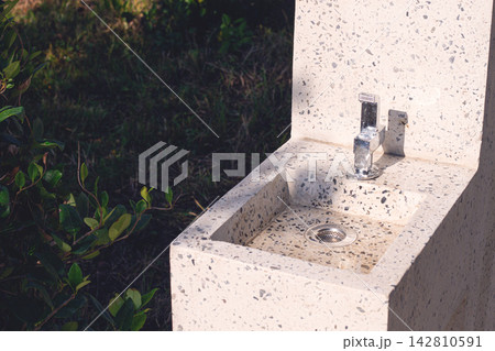 Modern outdoor sink with terrazzo design in a garden setting under sunlight 142810591