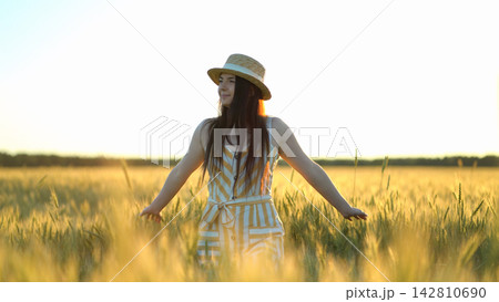 woman walking in a field with open arms woman walking in a field with open arms 142810690