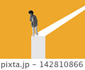 Woman standing at edge of an elevated path and considering her next step. 142810866