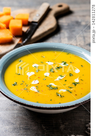 Creamy pumpkin soup with herbs and cream Creamy pumpkin soup with herbs and cream 142811278