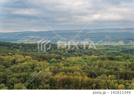 Layers of green mountains and hills in the haze during sunset. Panoramic View of Green hills and Meadow. Layers of green mountains and hills in the haze during sunset. Panoramic View of Green hills and Meadow. 142811349
